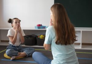 psychologist-helping-girl-speech-therapy-min